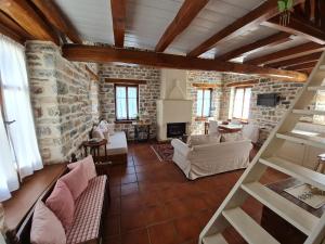 a large living room with a stone wall at Amanita in Tsagarada