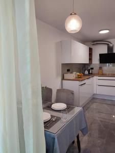 a kitchen with a table with two plates on it at Apartman Ivan in Kaštela