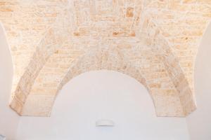 an arch in a brick wall with a ceiling at La Casetta di Chloè in Ostuni