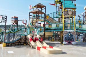 a water park with a slide and a train at Jellystone Park™ at Larkspur in Larkspur