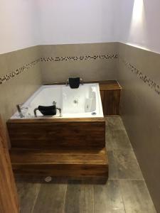 a bath tub with a sink in a room at Camellón de la Ferrería in Pacho