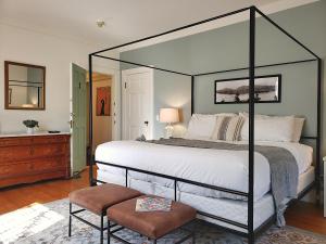 a bedroom with a bed, chair, and lamp at Hearthside Inn in Bar Harbor