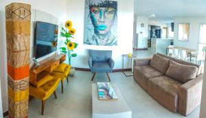 un soggiorno con divano e un dipinto sul muro di Beach house - secured, beach access, sea view, best location a Baixio