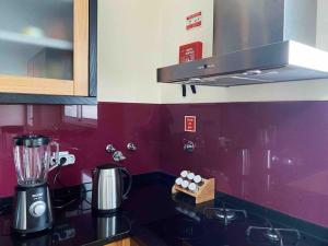 uma cozinha com um liquidificador em cima de um balcão em Brazão Guest House em Santana