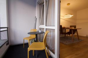 a room with a table and chairs and a dining room at Ferienwohnung Dreiländereck 1 in Lörrach
