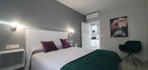 Posteľ alebo postele v izbe v ubytovaní Apartamentos Harmonia