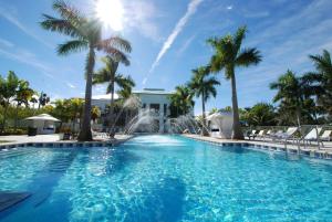 a pool with a fountain in a resort with palm trees at Modern Private Studio - King bed, Jacuzzi, Balcony and Pool in Miami