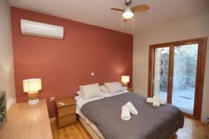 a bedroom with a bed and a window at Magna Grecia Residence Panoramic View in Episkopíon +27 photos