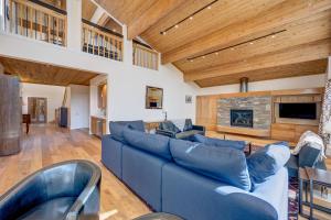 a living room with a blue couch and a fireplace at Mountain & Lake-View Delight in Truckee