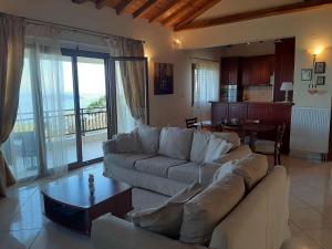 a living room with a couch and a table at Stathi's House in Megali Ammos