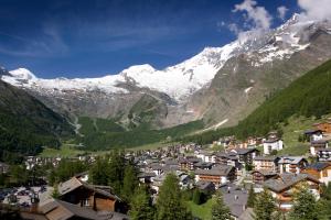 a town in a valley with snow capped mountains at Haus Shangri-La in Saas-Fee
