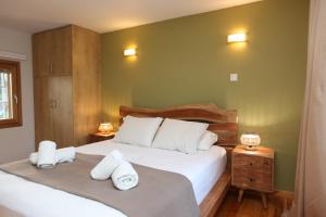 a bedroom with two beds and two towels at Picollo Grecia Residence Panoramic View in Ermoupoli