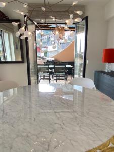 a dining room with a marble table and chairs at The Best view on Morcote in Morcote