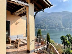 a house with a balcony with a view of a lake at The Best view on Morcote in Morcote