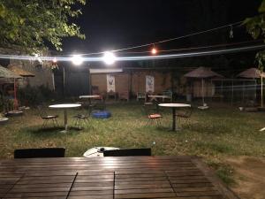 a group of tables and chairs in a yard at night at Zirkon Doğa Butik Otel in Fethiye