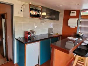 a small kitchen with blue cabinets and a counter top at Yangou Appart 2 in Mamoudzou +12 photos