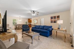 a living room with a blue couch and a table at Island House in Dauphin Island