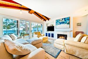 a living room with couches and a fireplace at Cliff View II in Laguna Beach