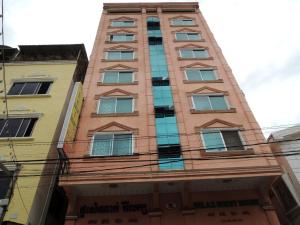 a tall red brick building with many windows at Relax Guesthouse in Phnom Penh