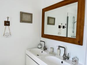 a bathroom with a sink and a mirror at La Casa D'Alauna in Valognes