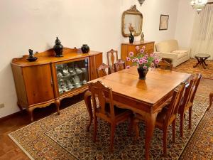 een eetkamer met een houten tafel en stoelen bij Casa Às Nove in Angra do Heroísmo