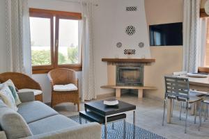 a living room with a couch and a table at Casa Abeja in Colonia de Sant Pere