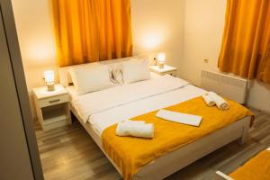 a bedroom with a bed with two towels on it at Darki Apartment - Bazaar Location With Free Parking in Ohrid