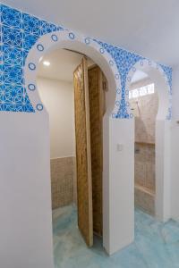 a bathroom with a blue and white tile wall at Guru Canggu in Canggu
