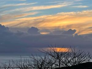 a view of a sunset with clouds in the sky at Casa Às Dez in Angra do Heroísmo