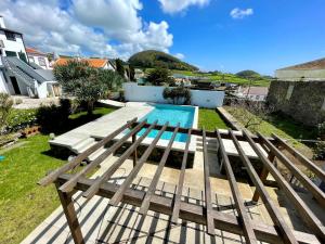 a view of a swimming pool from the balcony of a house at Casa Às Dez in Angra do Heroísmo