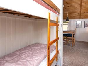 a bunk bed in a room with a table at 4 person holiday home in Hemmet-By Traum in Hemmet