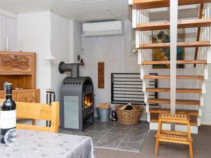 a living room with a wood stove in a room at 6 person holiday home in Hemmet in Hemmet