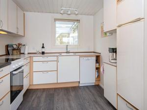 a kitchen with white cabinets and a window at 6 person holiday home in Hemmet in Hemmet