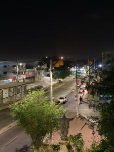 a city street at night with cars on the road at Hogar dulce hogar in Cartagena de Indias