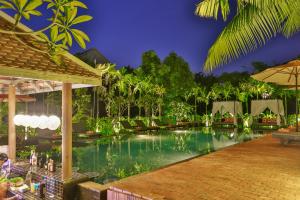 a pool in a resort at night at Home Indochine D'angkor Hotel in Siem Reap