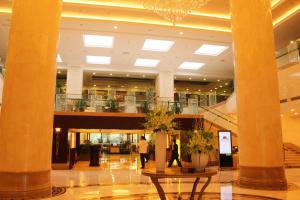 a lobby with columns and a chandelier in a building at Beijing Continental Grand Hotel in Beijing