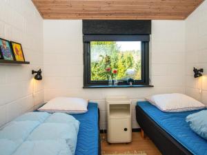 En eller flere senge i et værelse på Holiday home Ebeltoft CLXXXI