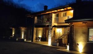 a house with lights on the side of it at night at B&B Casa Marvita in Cuneo