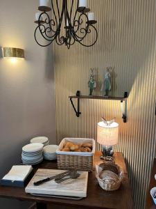 a table with a basket of bread and a lamp at Hotel garni Zum Rebstock in Naumburg