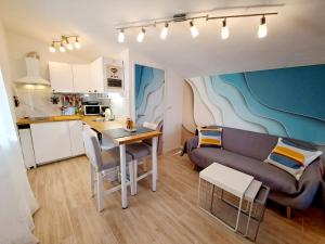 a kitchen and a living room with a couch and a table at Holiday Home Ulika in Fažana