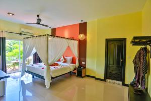 Postel nebo postele na pokoji v ubytování Home Indochine d'Angkor Hotel