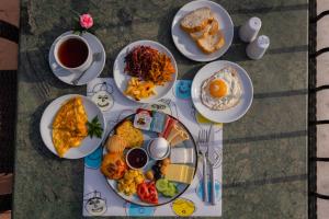 a table with plates of breakfast food and a cup of coffee at Agora Guesthouse in Istanbul