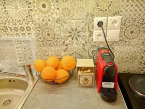 a bowl of oranges on a counter next to a sink at Marw's home in Nafplio +22 photos