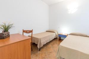 Rúm í herbergi á Le Dimore di Nettuno