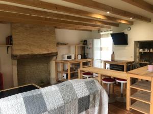 a living room with a couch and a brick fireplace at Chai Crann Piorra 2 in La Valade