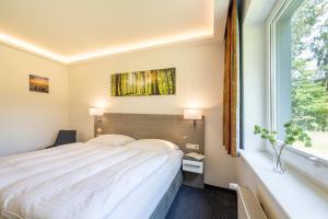 Ένα ή περισσότερα κρεβάτια σε δωμάτιο στο Hotel Mukran
