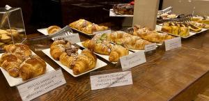 a display case in a bakery with a bunch of pastries at Hotel Principe di Piemonte in Rimini