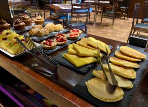 a buffet with different types of food and desserts at Hotel Principe di Piemonte in Rimini