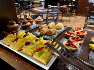 a table topped with different types of pastries and cakes at Hotel Principe di Piemonte in Rimini