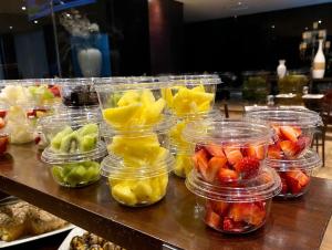a bunch of fruit in plastic containers on a table at Hotel Principe di Piemonte in Rimini